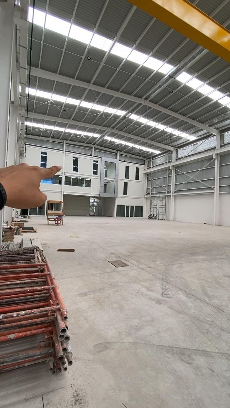 Interior of a near-complete warehouse with mezzanine office block and skylights