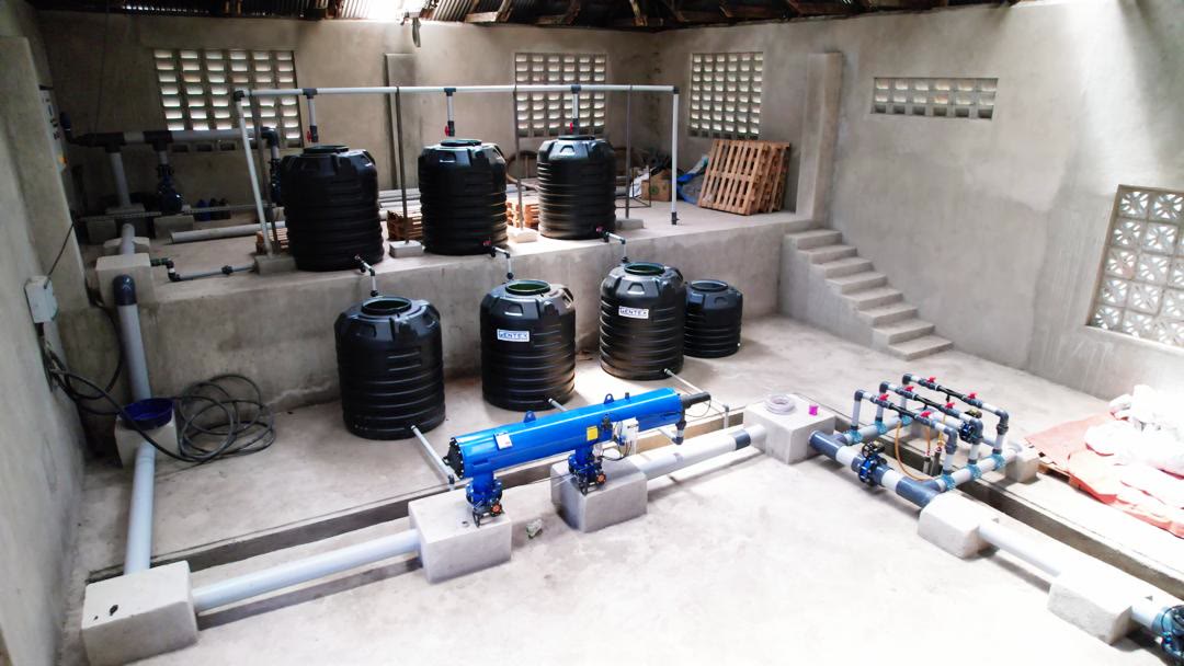 Installed water storage and treatment system inside a farm building